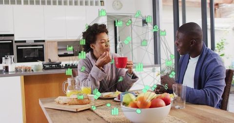 Couple enjoying breakfast with digital connection overlay