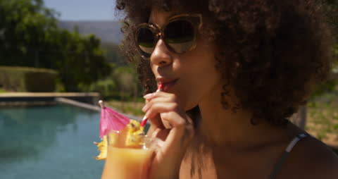 Relaxing by Poolside Enjoying Refreshing Piña Colada on Sunny Day