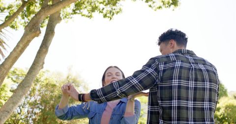 Joyful Couple Dancing Outdoors During a Sunny Day in Garden - Download Free Stock Images Pikwizard.com