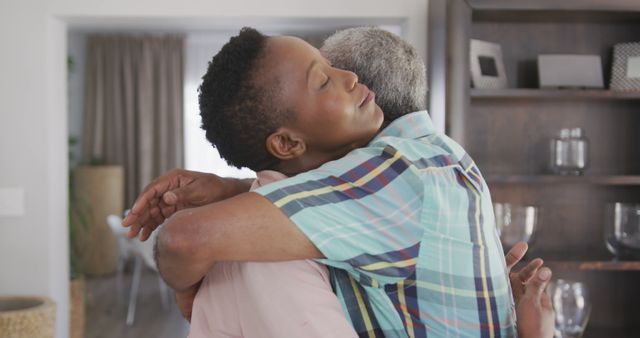 Comforting Hug Between Two Mature Adults in Living Room - Download Free Stock Images Pikwizard.com