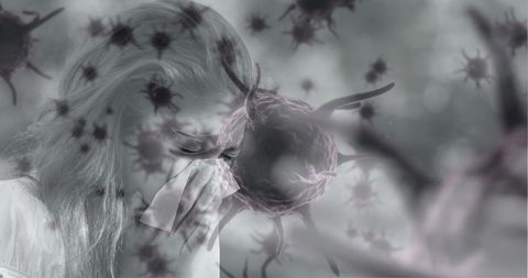 Woman blowing nose amidst illustrative virus cells