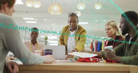 Diverse business team analyzing reports with global trends