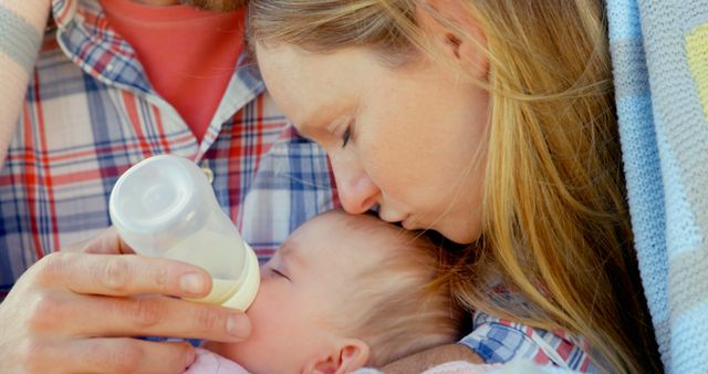 Mother Kissing Baby While Feeding Bottle - Download Free Stock Images Pikwizard.com