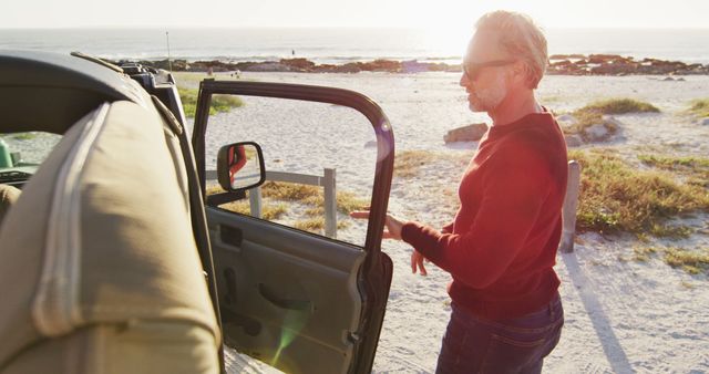 Man Enjoying Sunset at Beach Next to Open Car Door - Download Free Stock Images Pikwizard.com