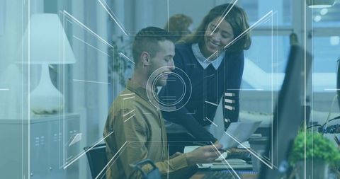 Colleagues Collaborating Over Report in Modern Office