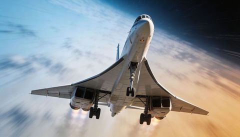 Supersonic jet climbing over sunrise with delta wings, landing gear down, afterburner trails