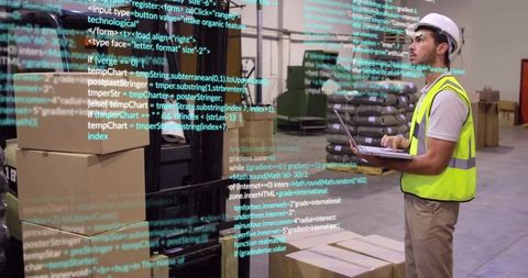 Warehouse worker using laptop driven by automation code overlay