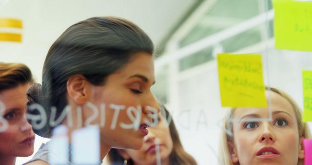 Group of Women Brainstorming Ideas with Sticky Notes in Office - Download Free Stock Images Pikwizard.com