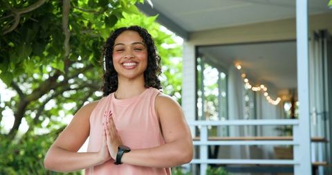 Smiling Woman Practicing Mindfulness Outdoors Among Greenery