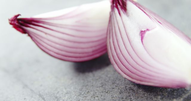 Close-Up of Freshly Cut Red Onion Halves on Grey Background - Download Free Stock Images Pikwizard.com