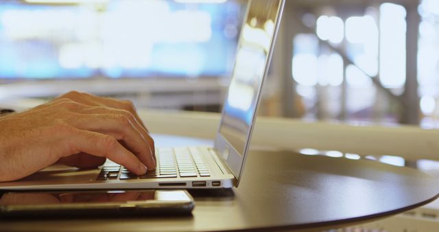 Person Typing on Laptop with Smartphone on Table - Download Free Stock Images Pikwizard.com