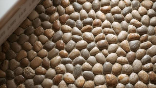 Rounded River Pebble Mosaic Flooring Featuring Smooth Stones and Thin Grout Texture