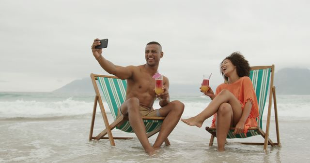 Young Couple on Beach Picnic Enjoying Tropical Drinks - Download Free Stock Images Pikwizard.com