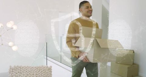 Hispanic man carrying cardboard boxes up modern staircase with glass railing