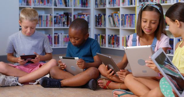 Diverse Group of Kids Learning Together on Tablets in Library - Download Free Stock Images Pikwizard.com