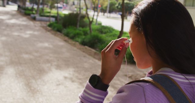 Female Runner Preparing Wireless Earbuds Outdoors - Download Free Stock Images Pikwizard.com