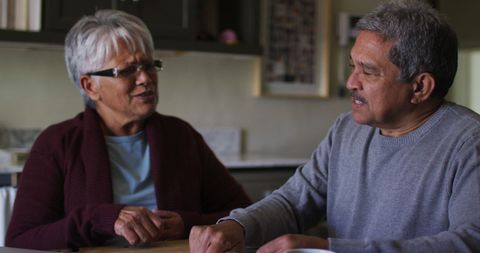 Smiling Senior Couple Discussing in Cozy Kitchen Setting - Download Free Stock Images Pikwizard.com