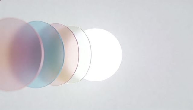 Overlapping frosted discs creating pastel translucent circles and backlit white glow