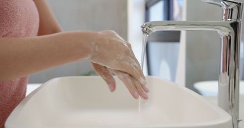 Hands Washing Under Modern Faucet for Hygiene and Sanitation