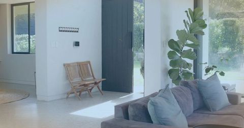 Minimalist living room featuring gray sectional sofa with blue-gray pillows and daylight