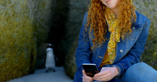 Redhead Reaching for Smartphone Outside on Sunny Day - Download Free Stock Images Pikwizard.com