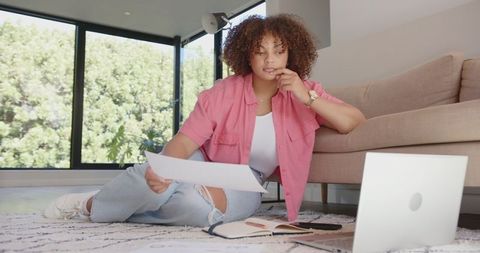 Woman in Relaxed Home Office Analyzing Documents