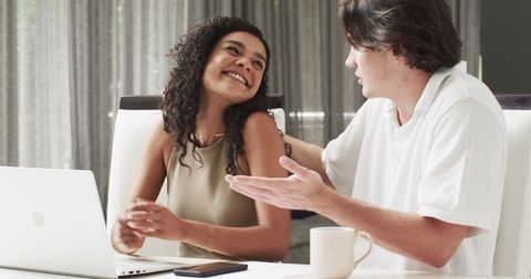 Happy Couple Chatting Over Coffee in Cozy Living Room