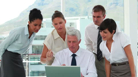 Diverse Team Collaborating with Boss on Project in Office