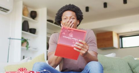 Happy Man Surprised by Romantic Gift at Home