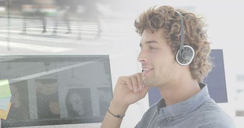 Young Businessman Using Headphones in Modern Office Environment