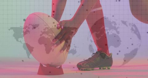 Athlete positioning rugby ball amidst abstract map projection