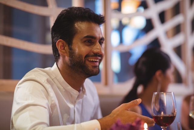 Man smiling while having meal in restaurant