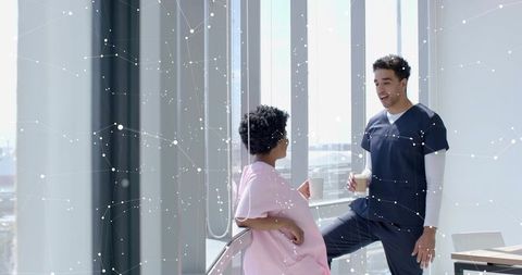 Pregnant patient and healthcare provider discussing by clinic window