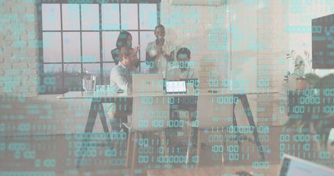 Collaborative team celebrating success in modern loft office with digital data overlay