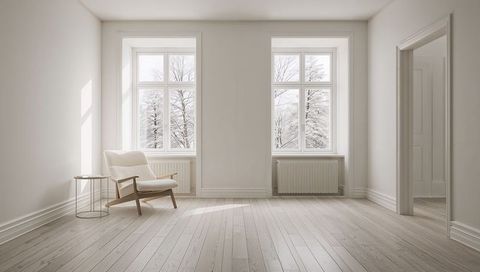 Minimal Scandinavian Living Room with Cozy Upholstered Lounge Chair by Winter Windows