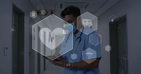 Doctor using tablet in hospital corridor with telemedicine interface and medical icons