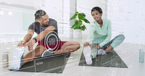 Couple stretching on mats with futuristic digital fitness overlays promoting wellness