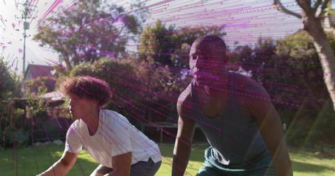 Two Men Doing Athletic Drills in Backyard Lawn with Vibrant Magenta Motion Light Streaks