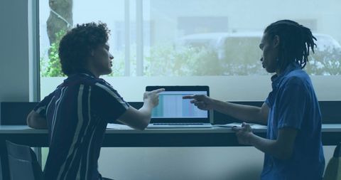 Colleagues Collaborating on Project in Bright Office