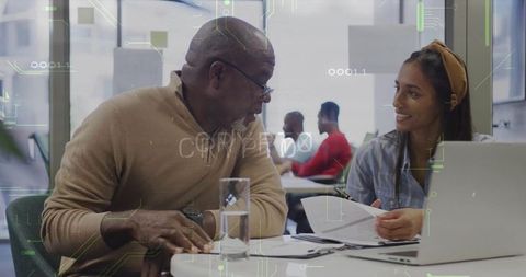 Mentor and Mentee Collaborating in Modern Office Setting