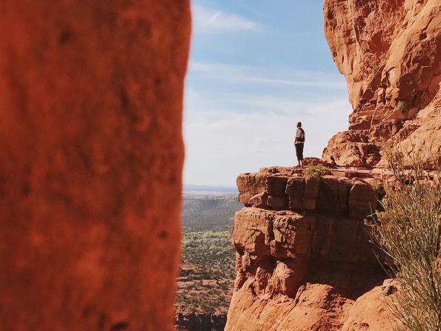 Person Standing on Cliff Edge in Desert Landscape - Download Free Stock Photos Pikwizard.com