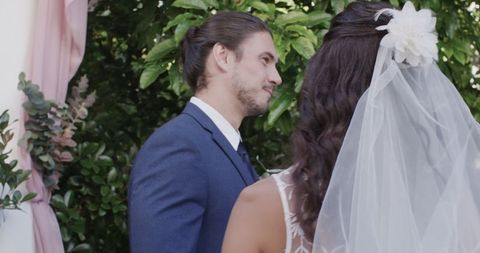 Groom in Blue Suit at Romantic Outdoor Wedding Ceremony