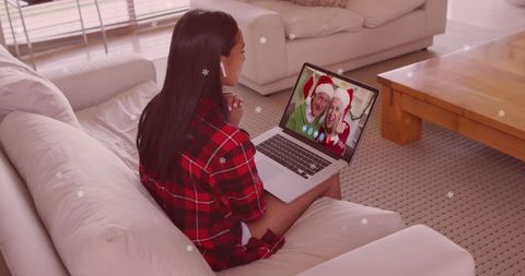 Woman Having Christmas Video Call with Family Members
