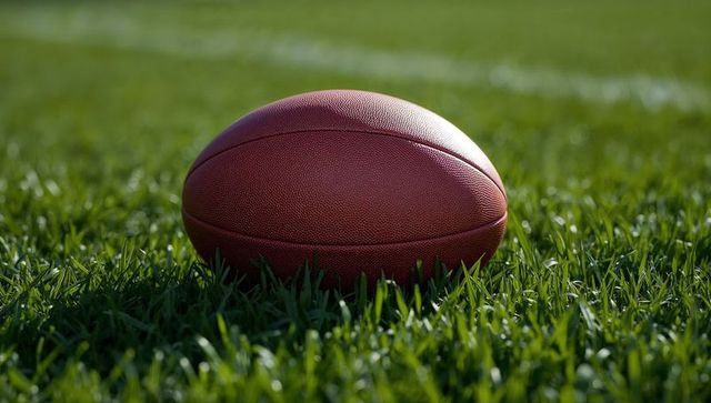 American football on grass field with yard line