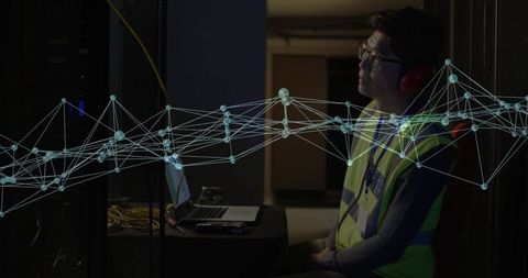 Technician in Server Room Monitoring Connectivity with Digital Network Overlay