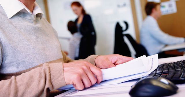 Employee Reading Documents in Busy Office Setting - Download Free Stock Images Pikwizard.com