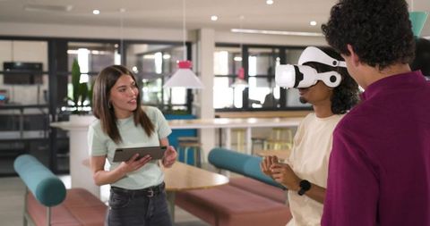 African American Team Demonstrating VR Headset in Modern Coworking Space for Collaboration
