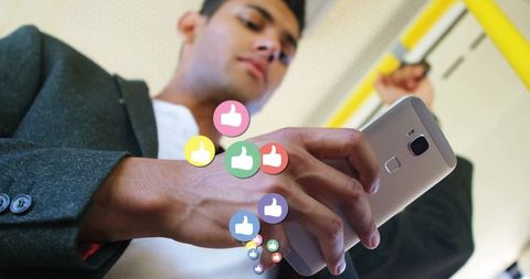 Engaged Young Man Using Smartphone on Public Transport