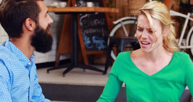 Couple Arguing in Café with Upset Expressions - Download Free Stock Images Pikwizard.com