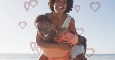Joyful Couple Enjoying Playful Moment by Sea